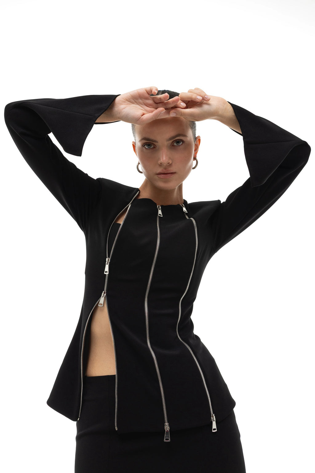 Woman wearing a black jacket with three zippers on a white background. Soluje