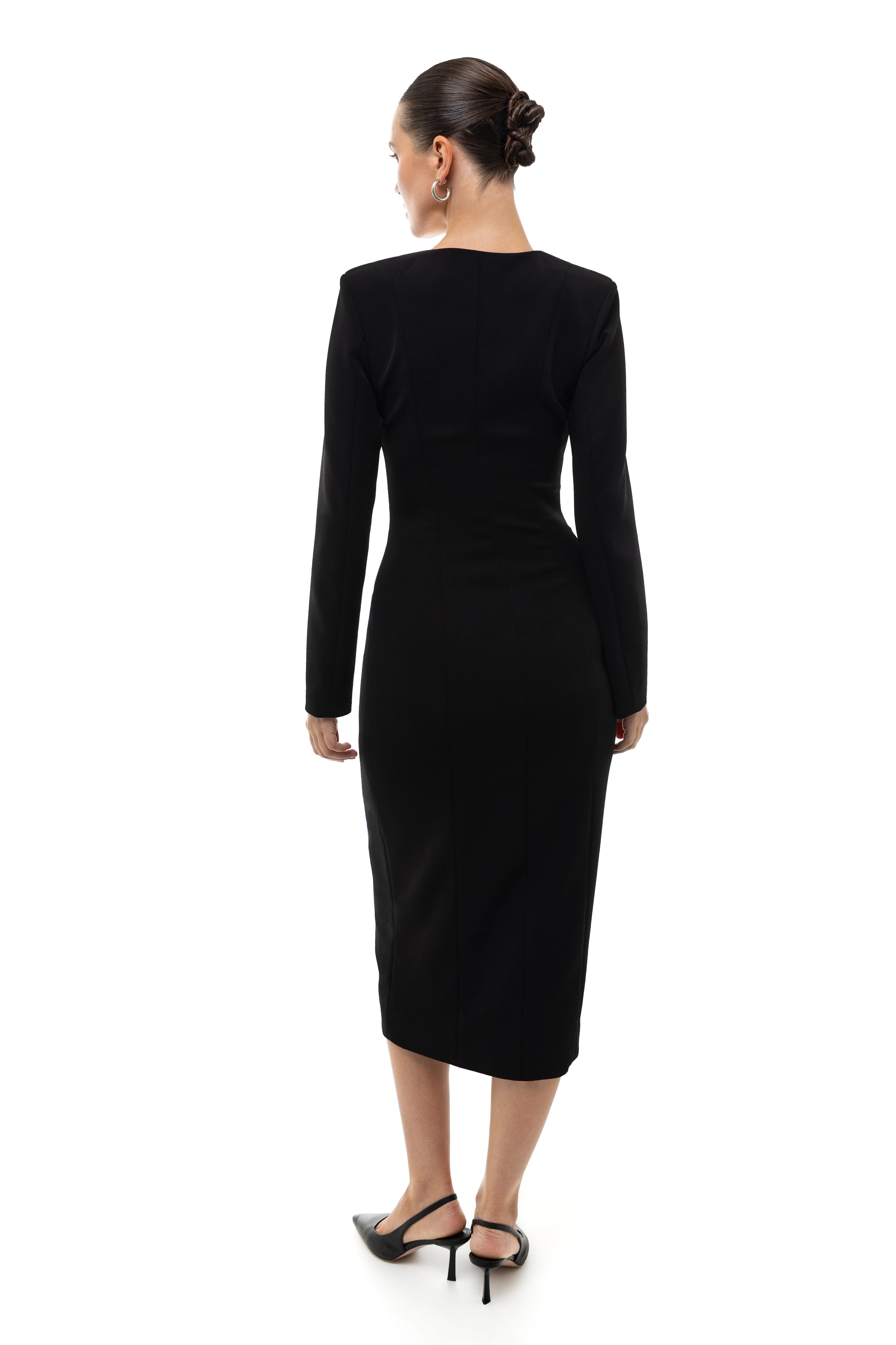 Woman wearing a black midi dress on a white background. 