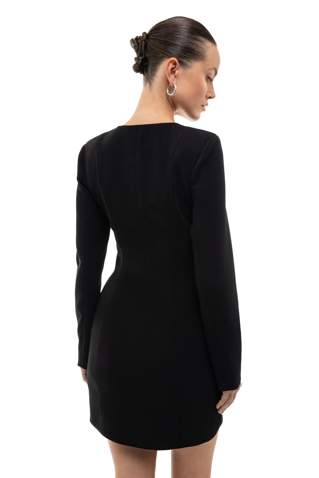 Black long-sleeve black dress with round hem on a model against a white background. soluje