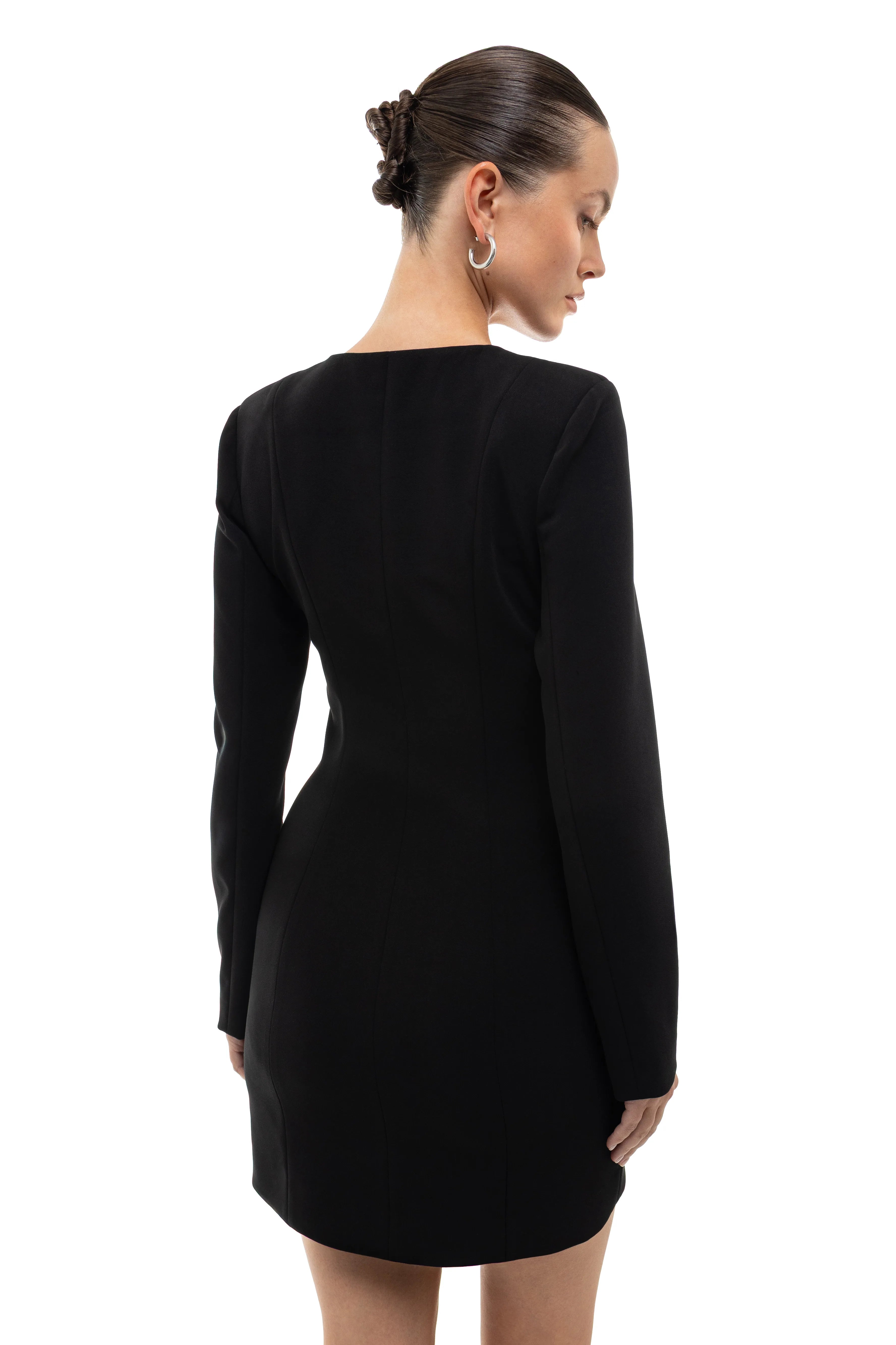 Black long-sleeve black dress with round hem on a model against a white background. soluje